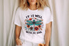 a woman wearing a t - shirt that says it is well with my soul
